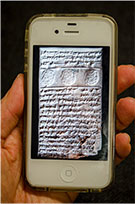 Photo of a clay tablet on a cell phone