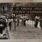 Black and white photograph with people in the street and "Rwanda welcomes you" sign (Photograph described in Convoy by Beata Umubyeyi Mairesse, Flammarion, 2024)