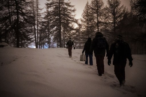 Group of men walking in a snowy forest