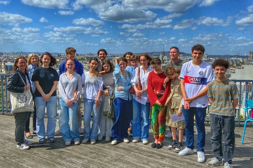 A group of middle and high school students on a guided tour of the Collège de France