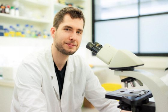 Pierre Bercier in front of a microscope