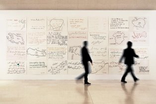 Collège de France foyer wall covered with migrants' texts