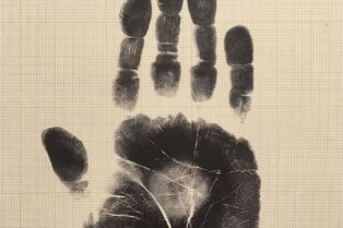 Handprint in ink on a notebook page