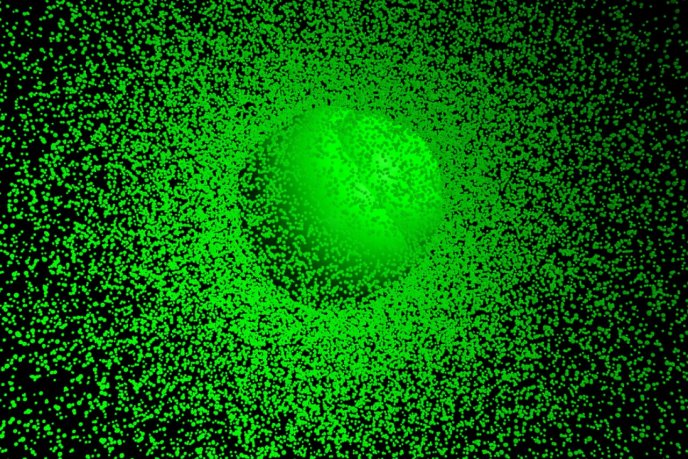 Effet lumineux vert fluo en forme de halo sur fond noir parsemé de points verts.