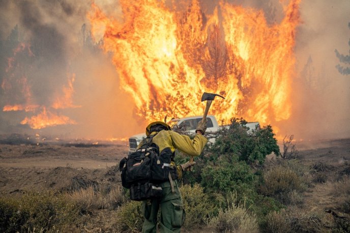Afficher l'image en plein écran : Pompier en lutte contre un incendie