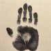 Handprint in ink on a notebook page