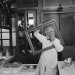 Man in smock behind empty frame