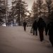 Group of men walking in a snowy forest