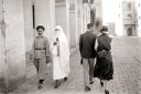  An Algerian couple and a European couple cross paths in an Algiers street 