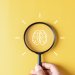Magnifying glass drawing of a brain on a yellow background