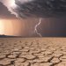 Desert expanse under a stormy sky with lightning