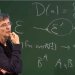 Thierry Coquand in front of a board full of mathematical formulas