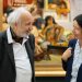 Deux personnes discutant devant un tableau